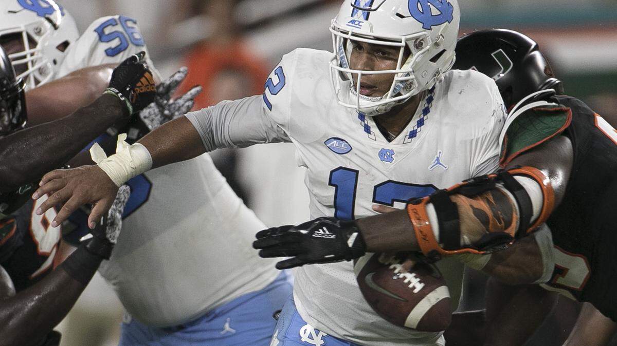Miami’s Joe Jackson (99) forces a fumble and sacks North Carolina quarterback Chazz Surratt (12) in the second quarter on Thursday, September 27, 2018 at Hard Rock Stadium in Miami Gardens, Florida.
