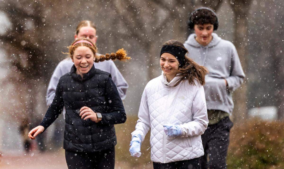 Runners brave the freezing temperature as snow begins to fall at UNC-Chapel Hill on Wednesday, Feb. 19, 2024.