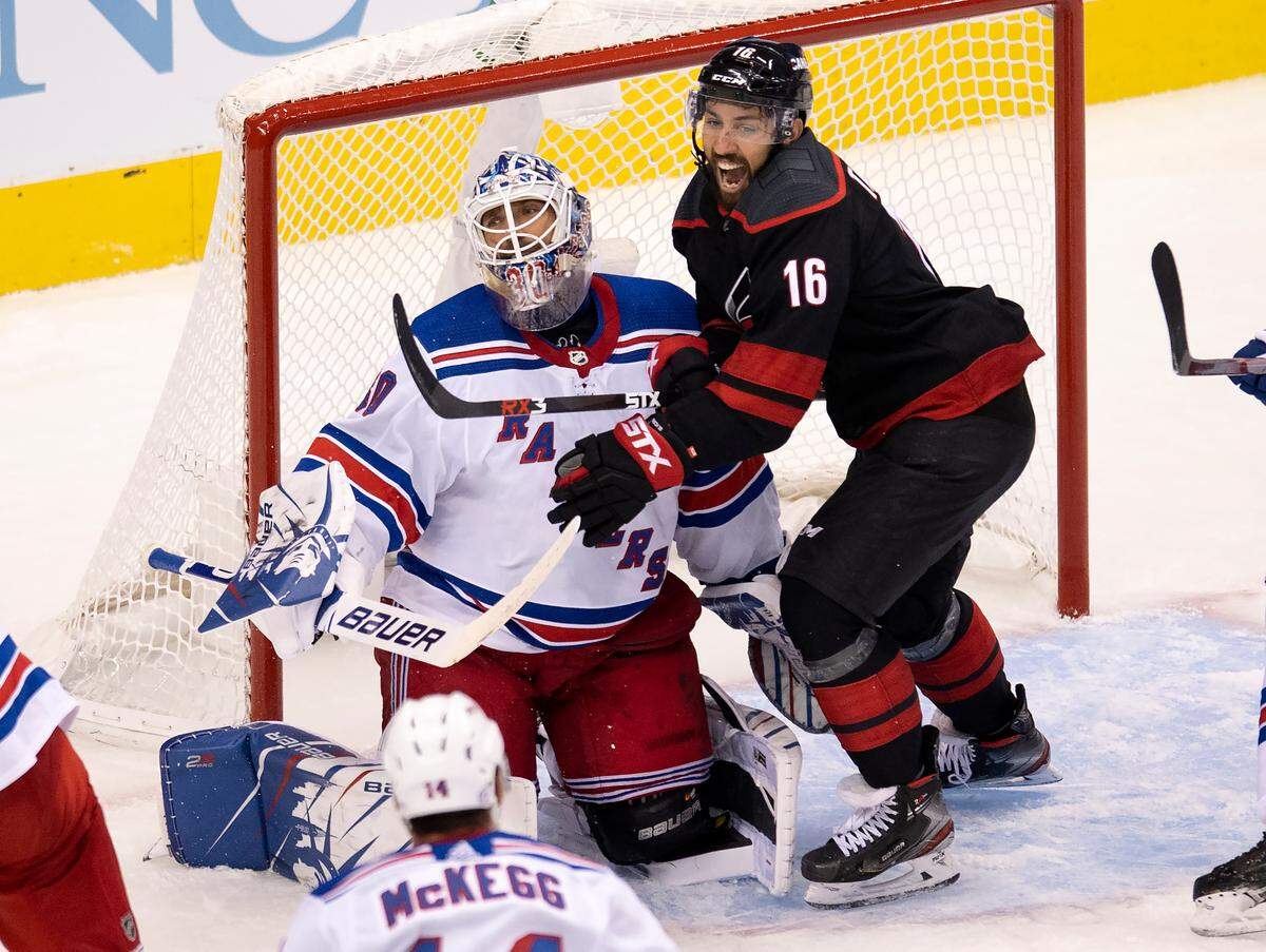 New York Rangers goaltender Henrik Lundqvist (30) reacts as Carolina Hurricanes center Vincent Trocheck (16) celebrates a goal by his team during the third period in the NHL hockey Stanley Cup playoffs in Toronto, Saturday, Aug. 1, 2020. (Frank Gunn/The Canadian Press via AP)