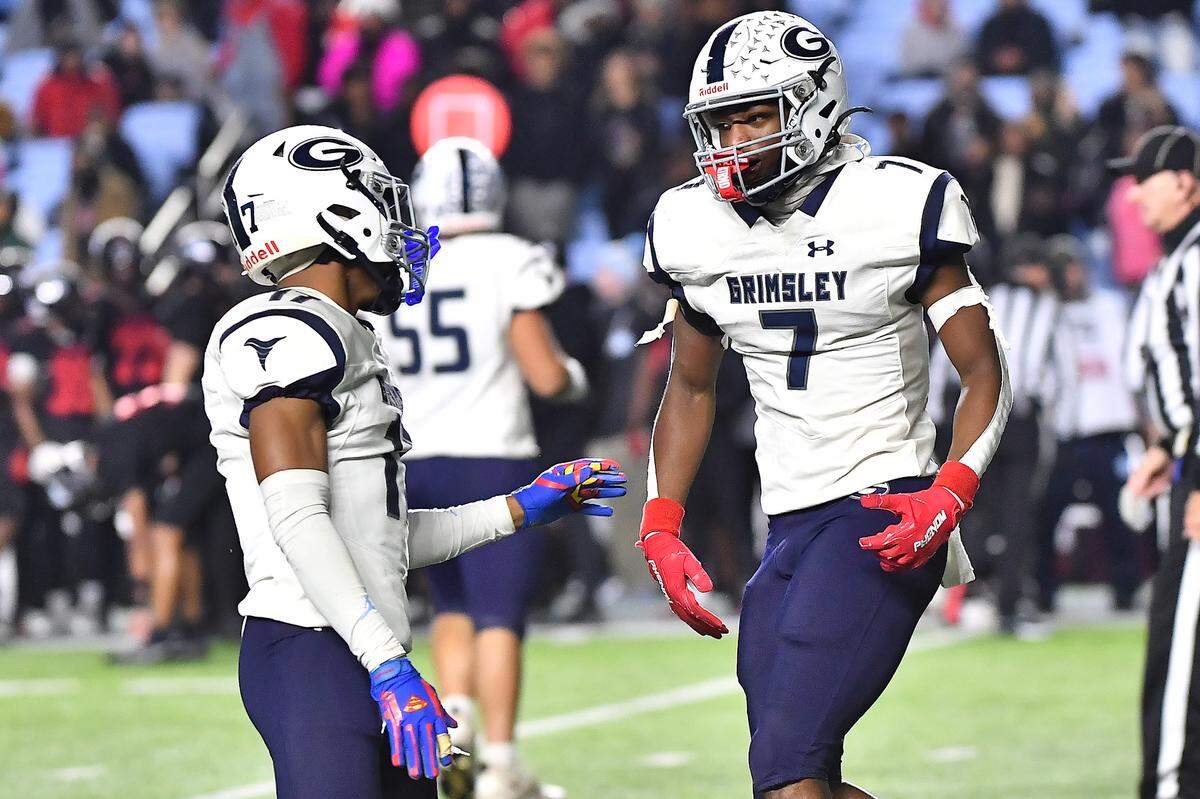 Grimsley’s EJ Davis (17) congratulates Ryan Debow (7) after his interception against Rolesville in the first half. The Rolesville Rams and the Greensboro Grimsley Whirlies met in the NCHSAA 4A football Championship Game in Chapel Hill, N.C. on December 20, 2024.