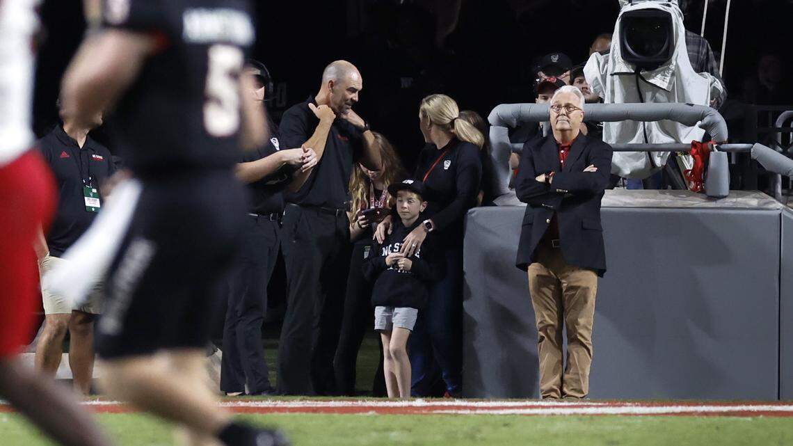 N.C. State Chancellor Randy Woodson, right, watches during the Wolfpack’s game against Louisville at Carter-Finley Stadium in Raleigh, N.C., Friday, Sept. 29, 2023.