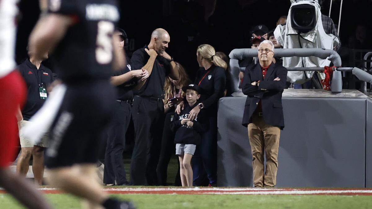 N.C. State Chancellor Randy Woodson, right, watches during the Wolfpack’s game against Louisville at Carter-Finley Stadium in Raleigh, N.C., Friday, Sept. 29, 2023.