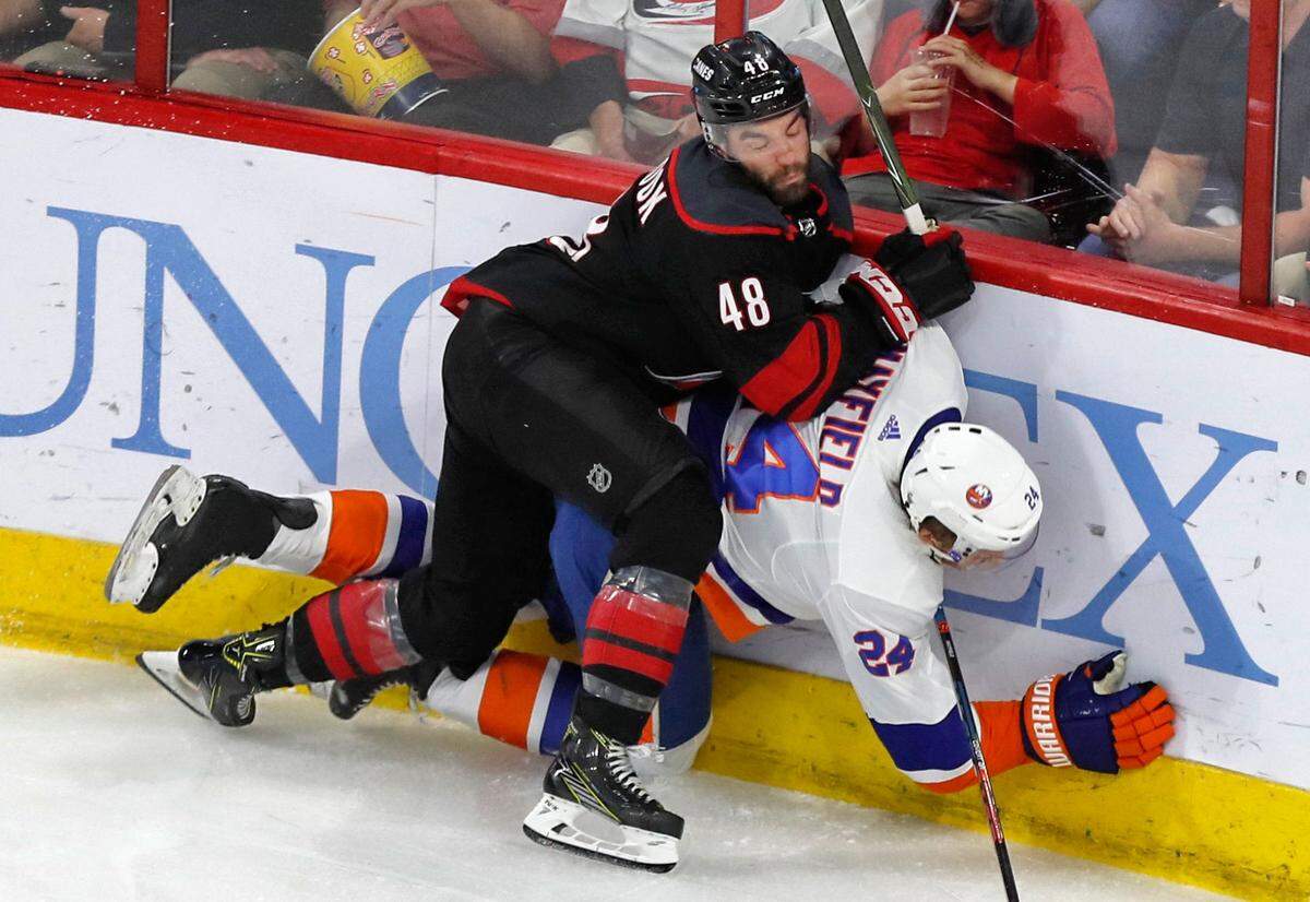 Carolina’s Jordan Martinook (48) checks New York’s Scott Mayfield (24) during the first period of the Carolina Hurricanes’ game against the New York Islanders at PNC Arena in Raleigh Friday, May 3, 2019.