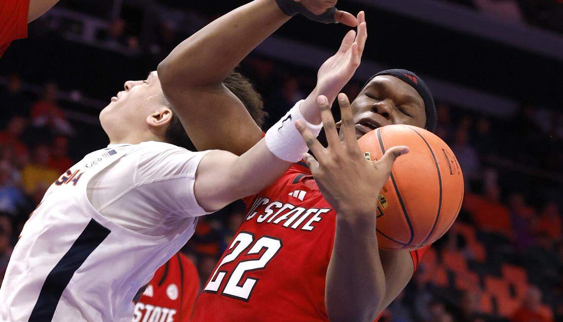 N.C. State's Ven-Allen Lubin (22) pulls the rebound from Virginia's Chance Mallory (2) during the first half of N.C. State’s game against Virginia in the quarterfinals of the 2026 ACC Men’s Basketball Tournament at the Spectrum Center in Charlotte, N.C., Thursday, March 12, 2026.
