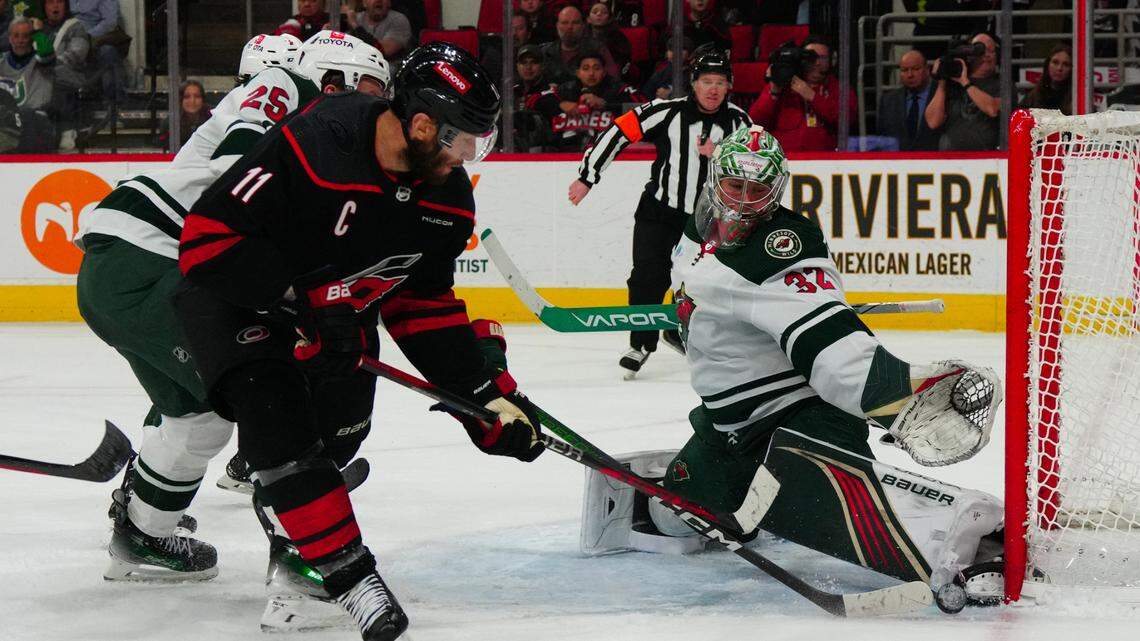 Jan 21, 2024; Raleigh, North Carolina, USA; Minnesota Wild goaltender Filip Gustavsson (32) stops the shot by Carolina Hurricanes center Jordan Staal (11) during the third period at PNC Arena. Mandatory Credit: James Guillory-USA TODAY Sports