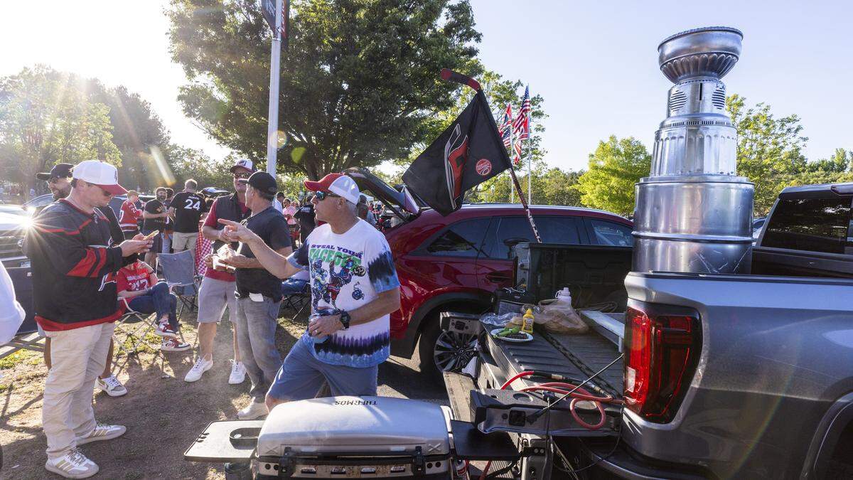 Carolina Hurricanes fans tailgate in the parking lot at the Lenovo Center in Raleigh on Tuesday, June 2, 2026, before Game 1 of the Stanley Cup Final. For the first time since 2006, the Hurricanes are playing in the Stanley Cup Final, facing the Vegas Golden Knights, who won the Stanley Cup in 2023.