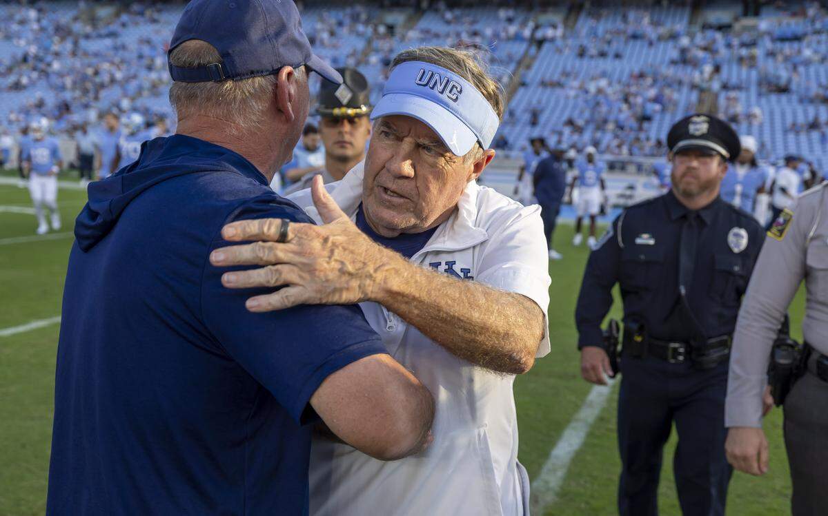 Richmond head coach Russ Huesman congratulates North Carolina coach Bill Belichick following the Tar Heels’ 41-6 victory on Saturday, September 13, 2025 at Kenan Stadium in Chapel Hill, N.C.