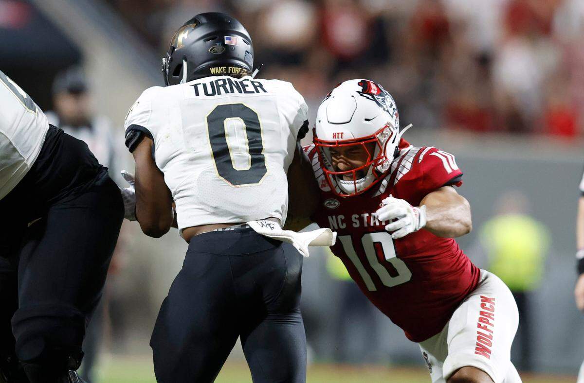 N.C. State’s Tanner Ingle (10) wraps up Wake Forest running back Christian Turner (0) during the second half of N.C. State’s 30-21 victory over Wake Forest at Carter-Finley Stadium in Raleigh, N.C., Saturday, Nov. 5, 2022.