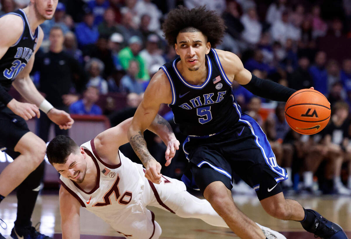 Duke’s Tyrese Proctor (5) drives past Virginia Tech’s Hunter Cattoor (0) during the first half of Duke’s game against Virginia Tech at Cassell Coliseum in Blacksburg, Va., Monday, Jan. 29, 2024.