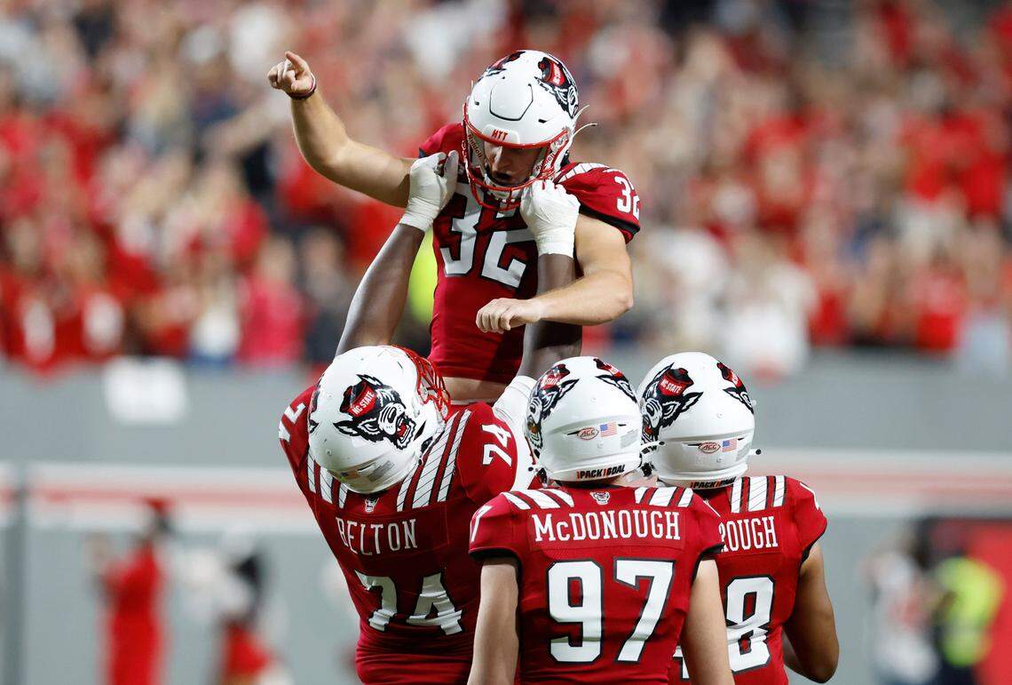 N.C. State’s Christopher Dunn (32) is hoisted by Anthony Belton (74) after he kicked a field goal in the second half of Boston College’s 21-20 victory over N.C. State at Carter-Finley Stadium in Raleigh, N.C., Saturday, Nov. 12, 2022. The field goal set a new ACC career field goal record.