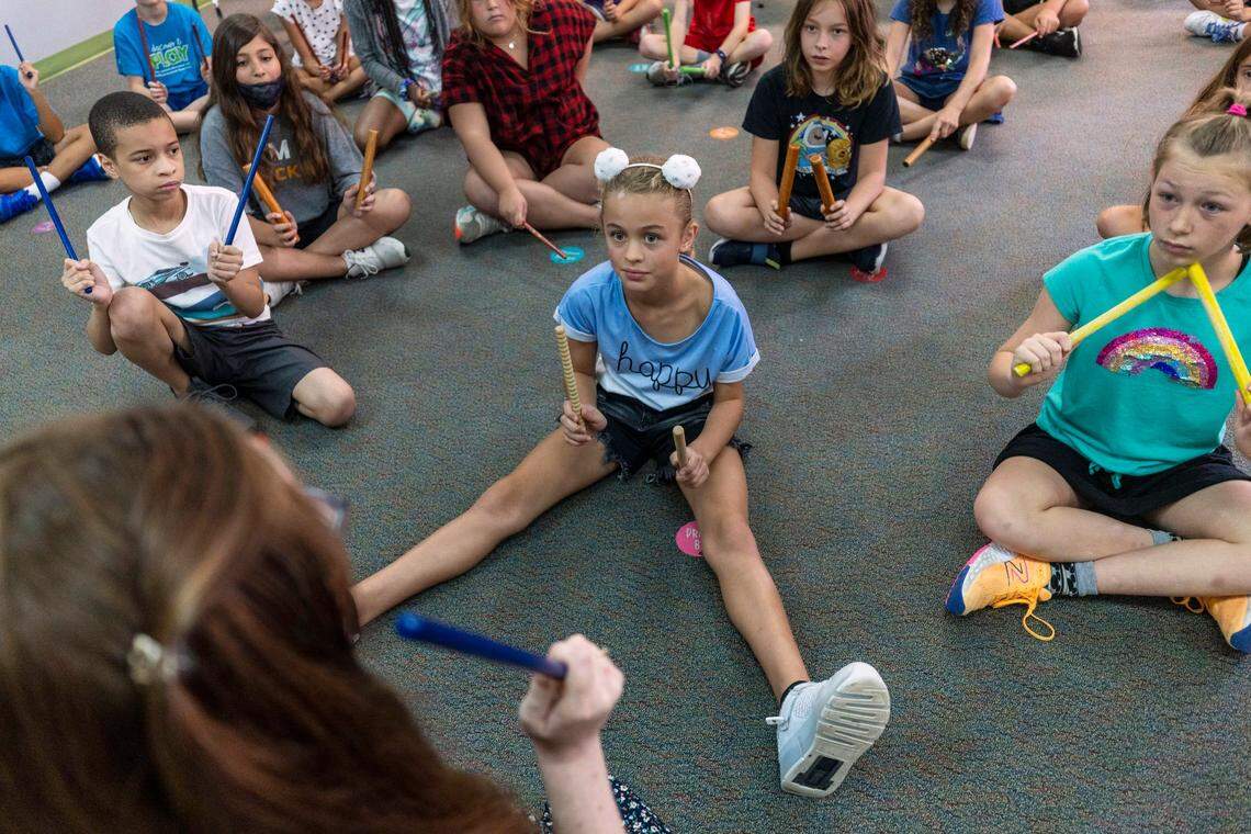 Lena Biron, a fifth grader at Sycamore Creek Elementary School, listens intently to music teacher Liz Yardley during class in this 2022 file photo. Sycamore Creek is among 11 Wake County year-round schools that could have its calendar converted.