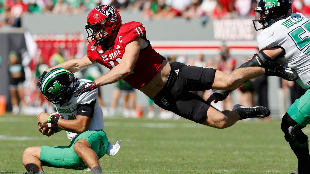 N.C. State linebacker Payton Wilson (11) tackles Marshall quarterback Cam Fancher (14) during the first half of N.C. State’s game against Marshall at Carter-Finley Stadium in Raleigh, N.C., Saturday, Oct. 7, 2023.