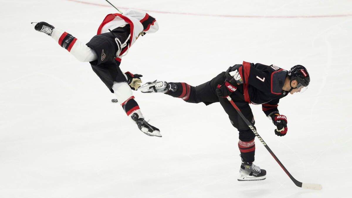 The Carolina Hurricanes Dmitry Orlov (7) hip checks Ottawa’s Mathieu Joseph during the third period on Wednesday, October 11, 2023 at PNC Arena, in Raleigh N.C.