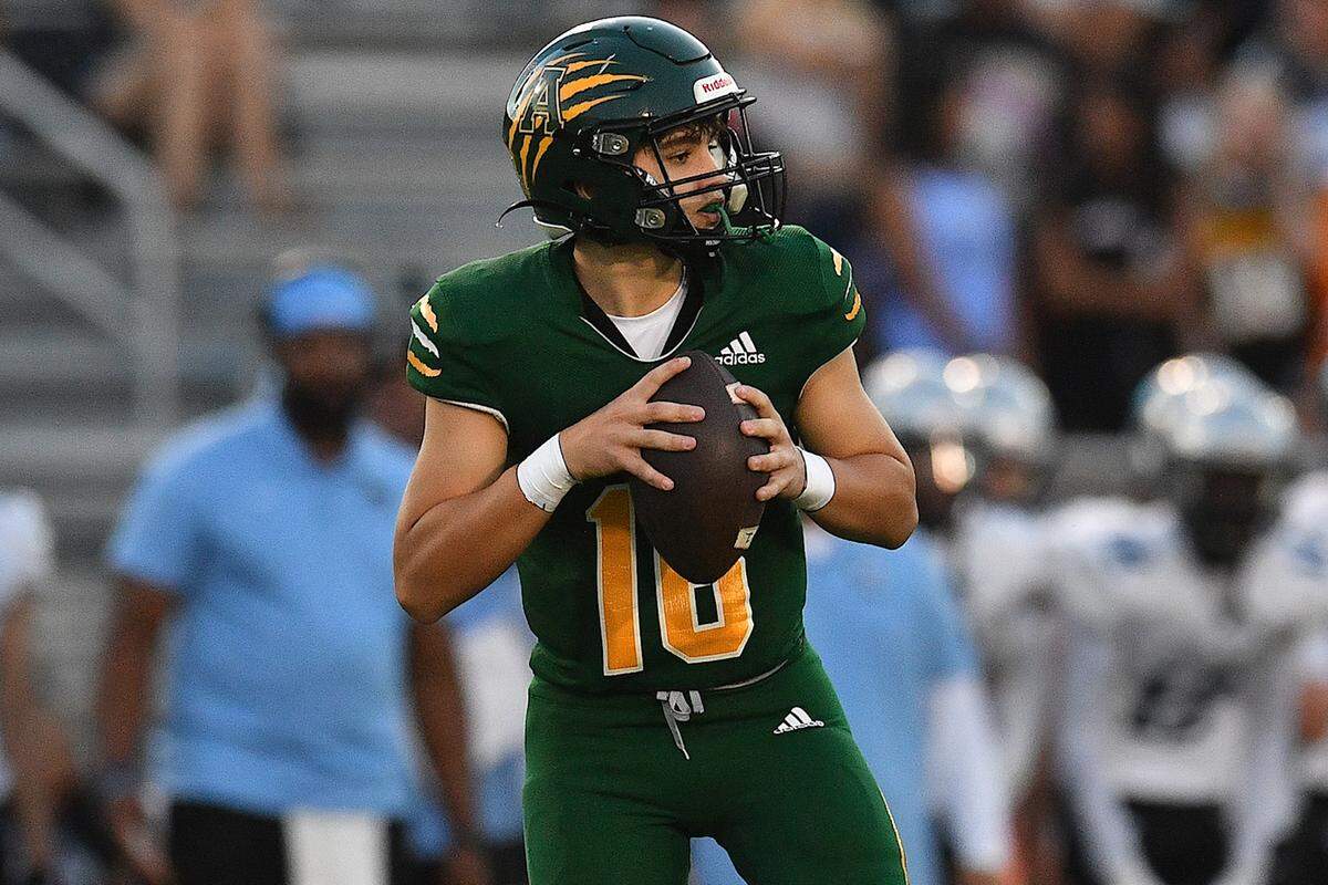 Apex quarterback Kyle Hulse (16) looks to pass against Panther Creek during the first half. The Apex Cougars and the Panther Creek Catamounts met in a conference football game in Apex, N.C. on September 20, 2024.