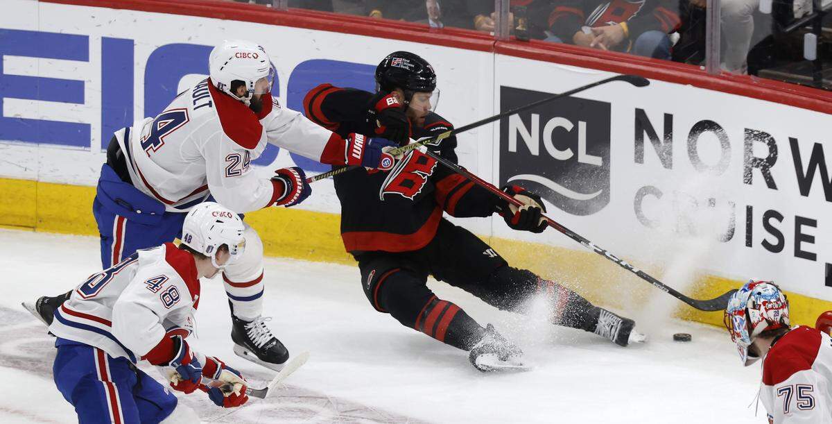 Carolina's Taylor Hall (71) goes after the puck while defended by Montréal's Phillip Danault (24) during the second period of the Hurricanes’ game against the Canadiens in game one of the Eastern Conference Finals at the Lenovo Center Thursday, May, 21, 2026.