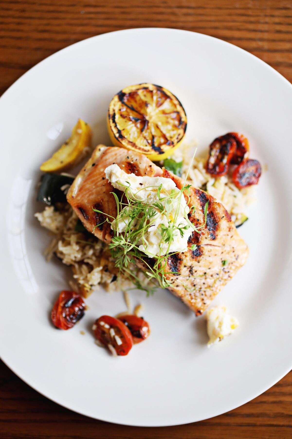 Pickle Jar Cafe’s salmon is served with cilantro rice, roasted zucchini and squash and tomatoes.
