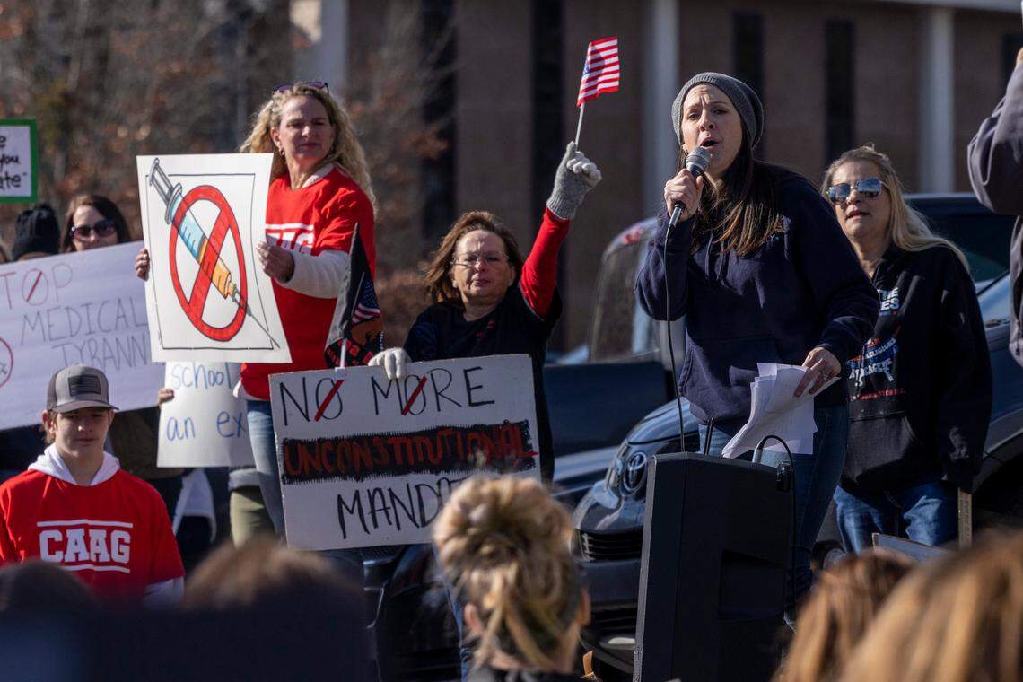 Demonstrators opposed to vaccine requirements protest outside the The N.C. Commission for Public Health in Raleigh Wednesday, Feb. 2, 2022. The commission unanimously voted against a rule-making petition from four UNC System professors to add the COVID vaccine to state immunization requirements for people who are 17 years old or who are entering 12th grade as of July 1.