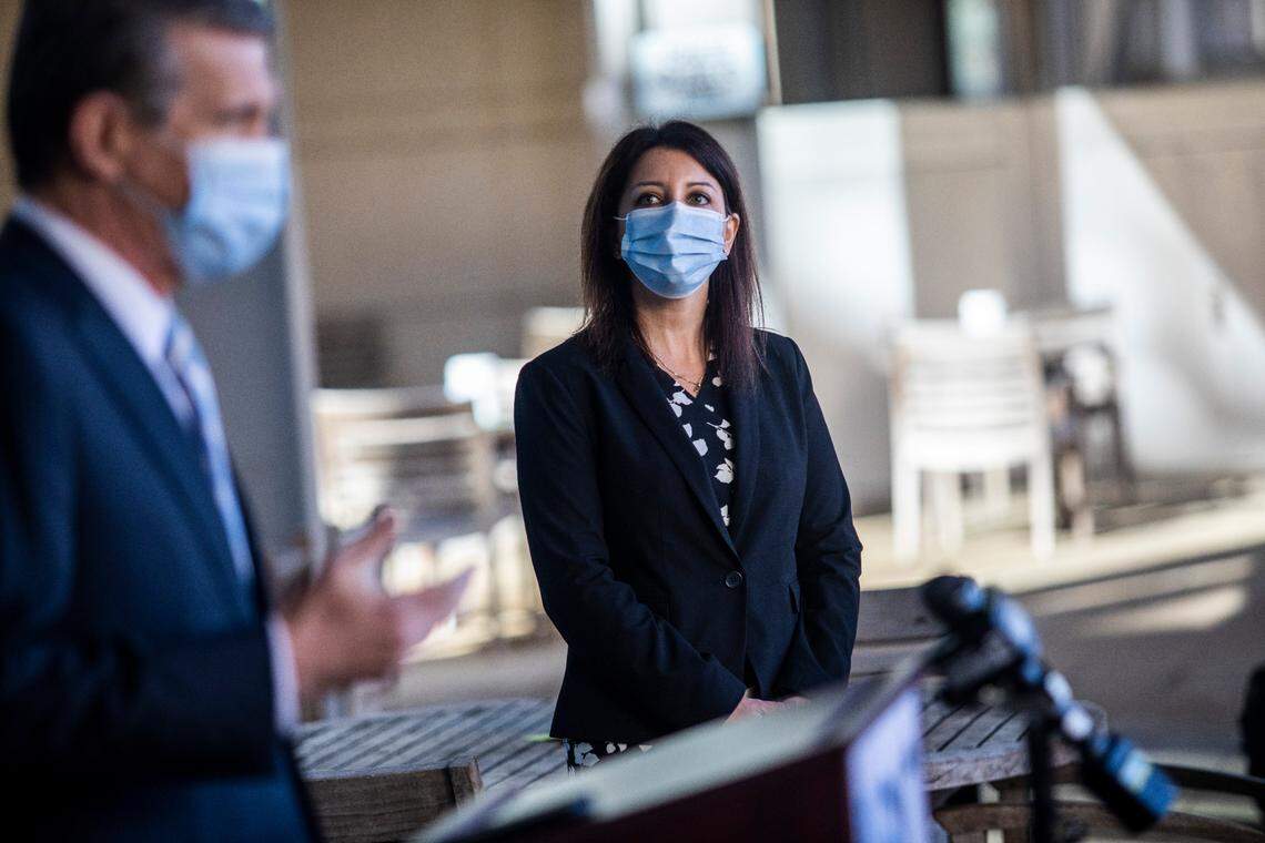 Secretary of the NC Department Health and Human Services Dr. Mandy Cohen watches as Gov. Roy Cooper during a press conference at UNC Health in Chapel Hill, NC Thursday, Dec. 7, 2020 where frontline healthcare workers are among some of the first recipients of the Pfizer COVID-19 vaccine.