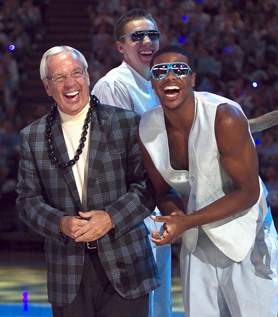 UNC head coach Roy Williams and Dexter Strickland laugh as Joe Holladay, director of basketball operations shows off his dance moves during the annual “Late Night With Roy” kick off to the basketball season on Friday October 12, 2012 at the Smith Center in Chapel Hill, N.C.