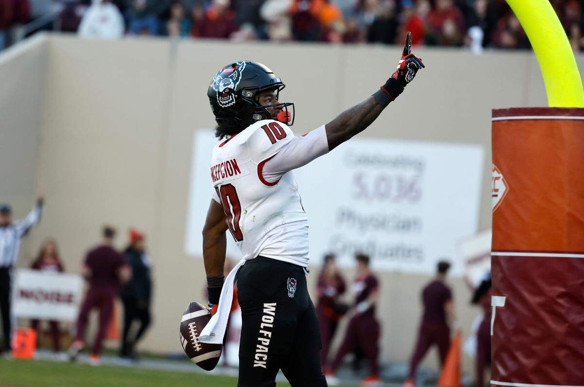 N.C. State wide receiver KC Concepcion (10) motions to the crowd after scoring on a 28-yard touchdown reception during the first half of N.C. State’s game against Virginia Tech at Lane Stadium in Blacksburg, VA, Saturday, Nov. 18, 2023.