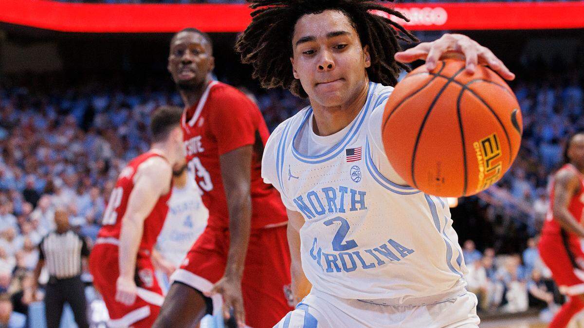 North Carolina’s Elliot Cadeau attempts to save the ball from going out of bounds during the first half of the Tar Heels’ game against N.C. State on Saturday, March 2, 2024, at the Smith Center in Chapel Hill, N.C.