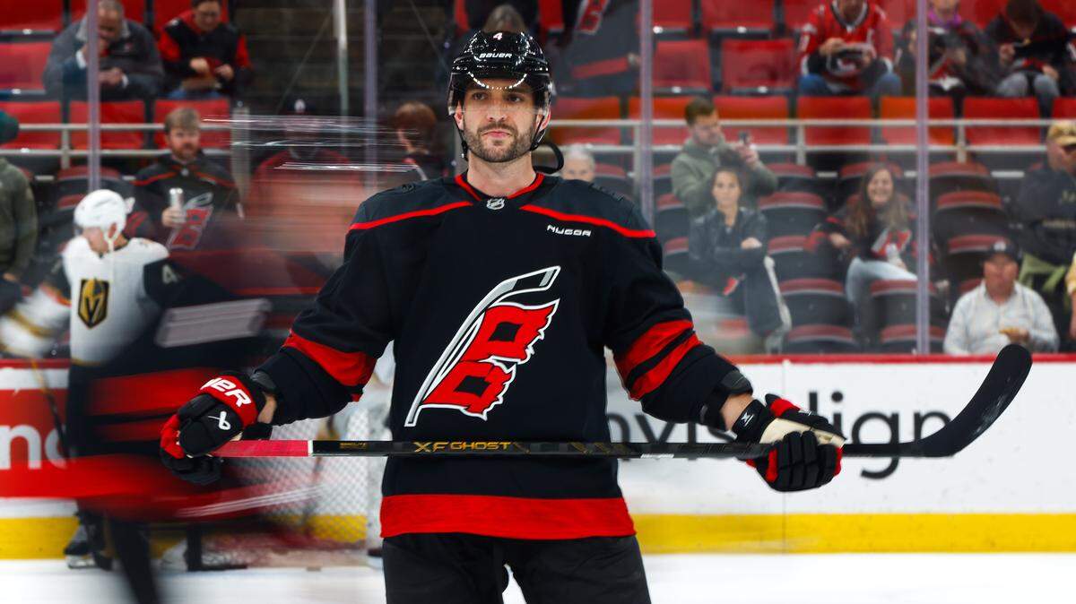 Shayne Gostisbehere of the Carolina Hurricanes looks on during warm-up before the game against the Vegas Golden Knights at Lenovo Center on Oct. 28, 2025 in Raleigh, North Carolina.