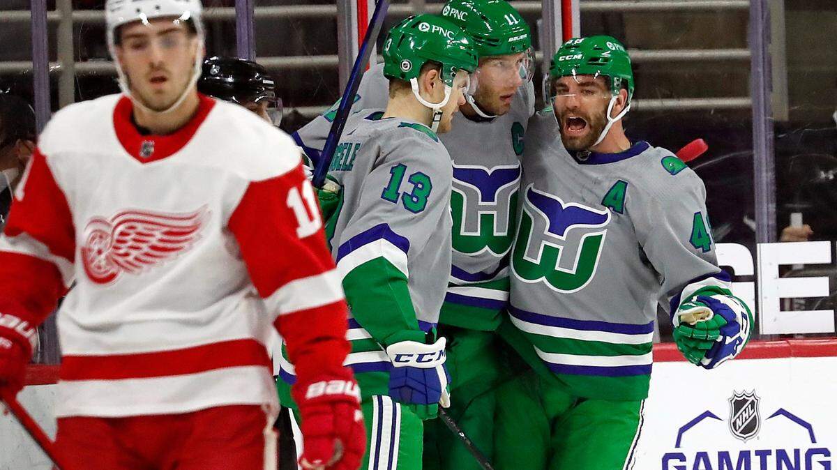 Carolina Hurricanes’ Jordan Staal (11), center, is congratulated on his goal by teammates Warren Foegele (13) and Jordan Martinook (48) during the first period of an NHL hockey game against the Detroit Red Wings in Raleigh, N.C., Saturday, April 10, 2021. (AP Photo/Karl B DeBlaker)