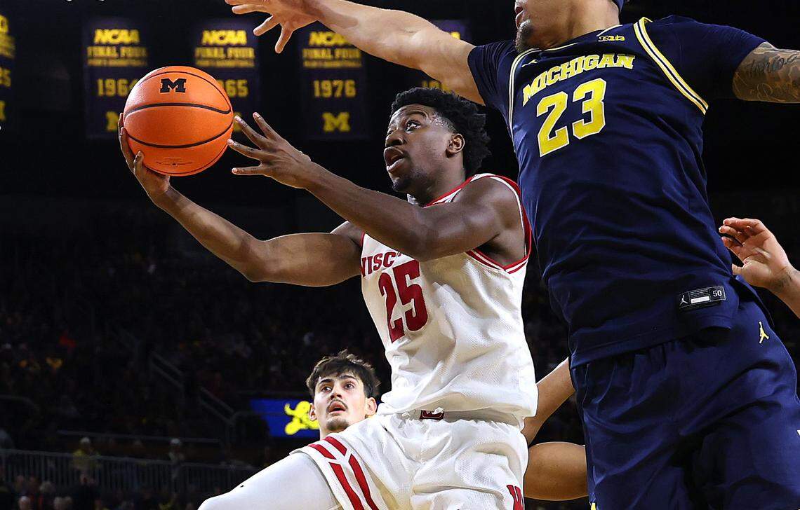 John Blackwell of the Wisconsin Badgers drives to the basket as Yaxel Lendeborg of the Michigan Wolverines defends during their game on January 10, 2026 in Ann Arbor, Michigan.