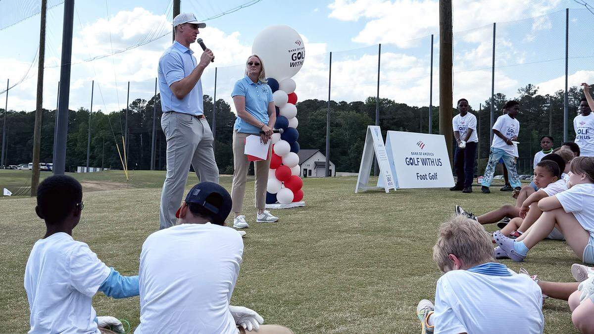 Former UNC basketball star Tyler Hansbrough speaks at a youth golf clinic at Raleigh’s TriGolf (home of the Triangle’s First Tee organization), offering instruction and encouragement to dozens of children.