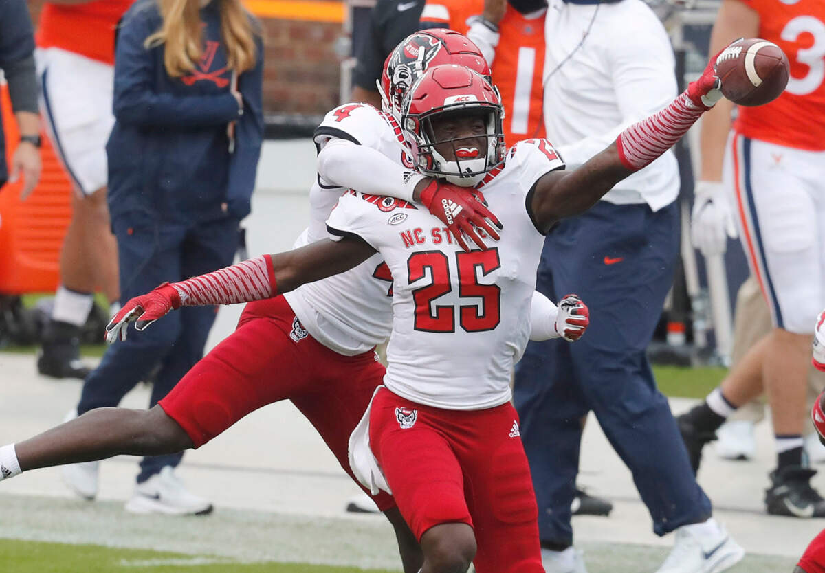 N.C. State cornerback Cecil Powell (4) celebrates with Shyheim Battle (25) after Battle intercepted the pass during the first half of N.C. State’s game against Virginia at Scott Stadium in Charlottesville, Va., Saturday, Oct. 10, 2020.