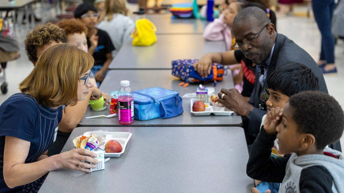 Cindy Long, Administrator of the USDA Food and Nutrition Service, left, and Robert Taylor, Wake County Schools Superintendent, eat lunch with students at Kingswood Elementary in Cary on Tuesday, June 4, 2024. Wake County school administrators briefed the school board Tuesday on a plan to potentially add 28 more schools to the federal government’s universal school meals program.