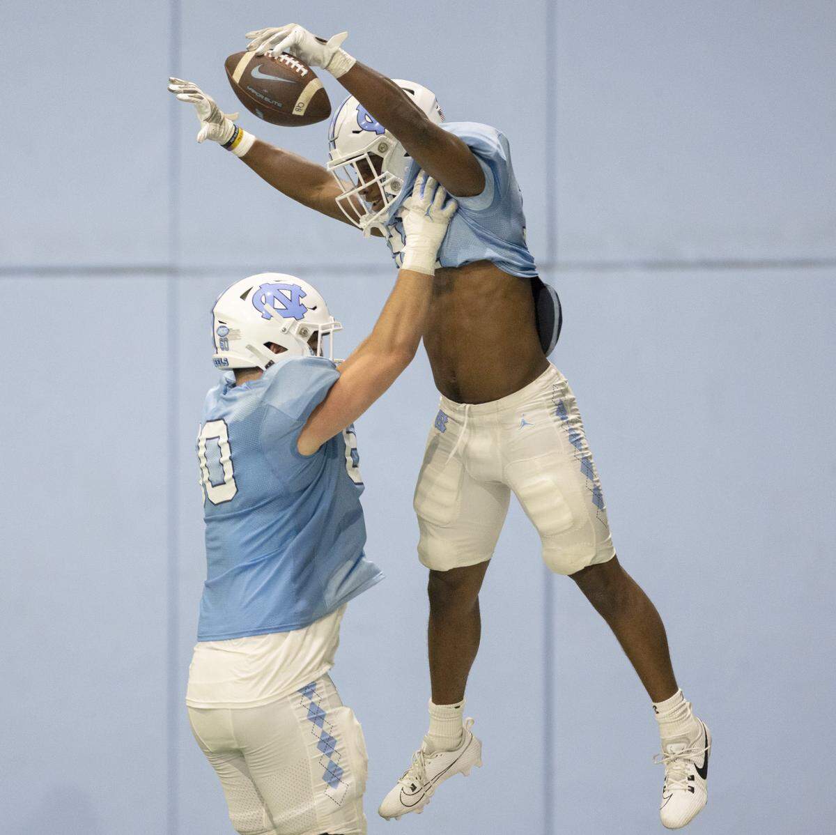 North Carolina offensive lineman Carter Kulka (60) hoists Major Byrd (32) after scoring a touchdown during the Tar Heels’ scrimmage on Thursday, April 11, 2024 in Chapel Hill, N.C.