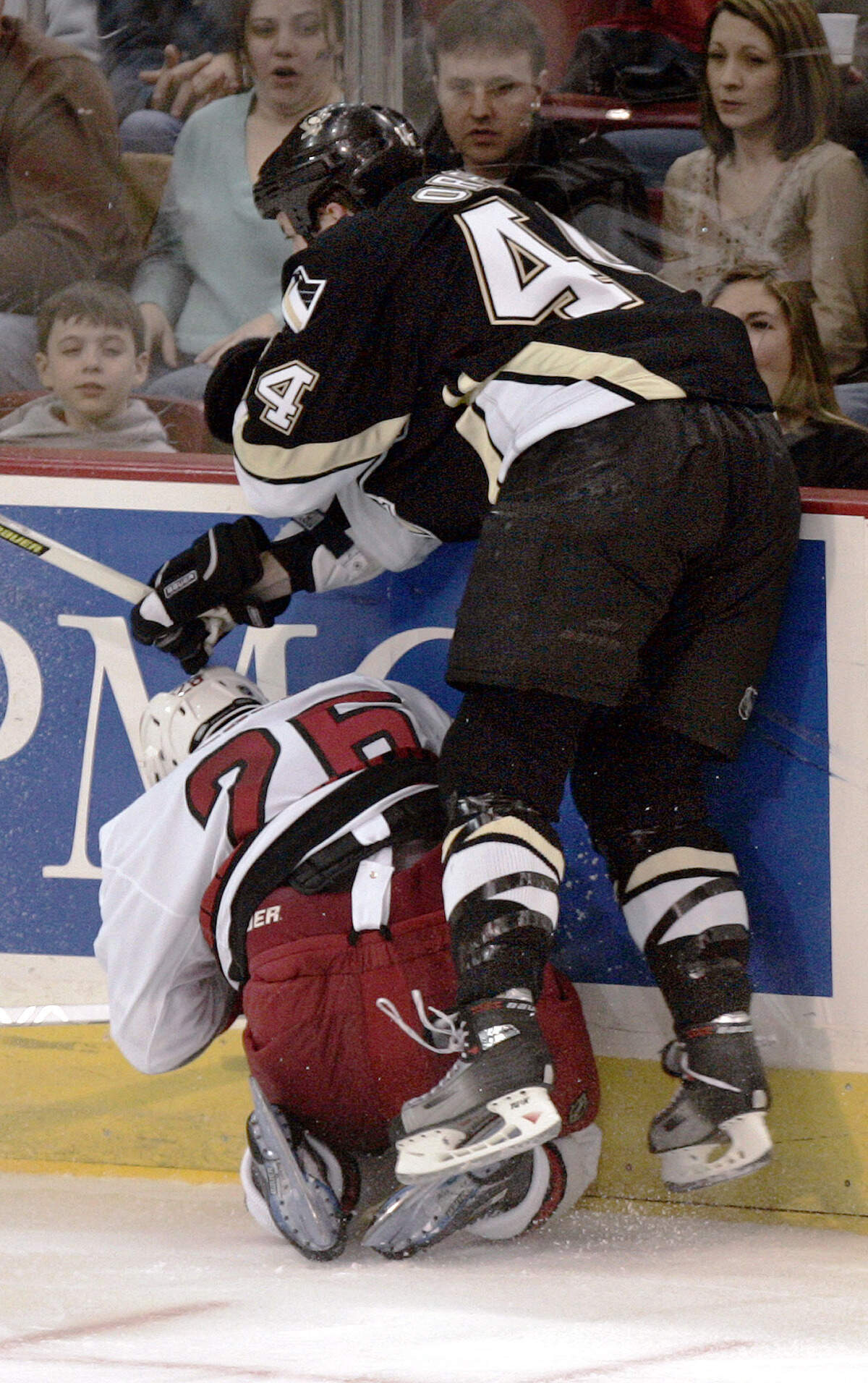 Pittsburgh Penguins’ Brooks Orpik (44) checks Carolina Hurricanes’ Erik Cole into the boards on Saturday, March 4, 2006. Orpik was penalized for boarding and given a game misconduct. Cole missed the rest of the regular season with a compression fracture in a vertebra in his neck caused by the hit.