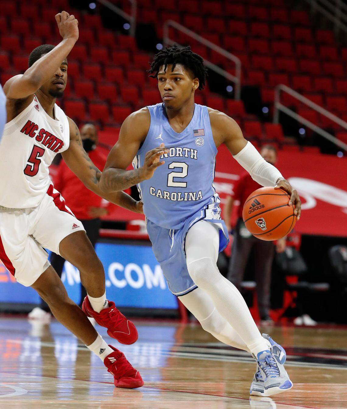North Carolina’s Caleb Love (2) drives past N.C. State’s Thomas Allen (5) during the second half of N.C. State’s 79-76 victory over UNC at PNC Arena in Raleigh, N.C., Tuesday, December 22, 2020.