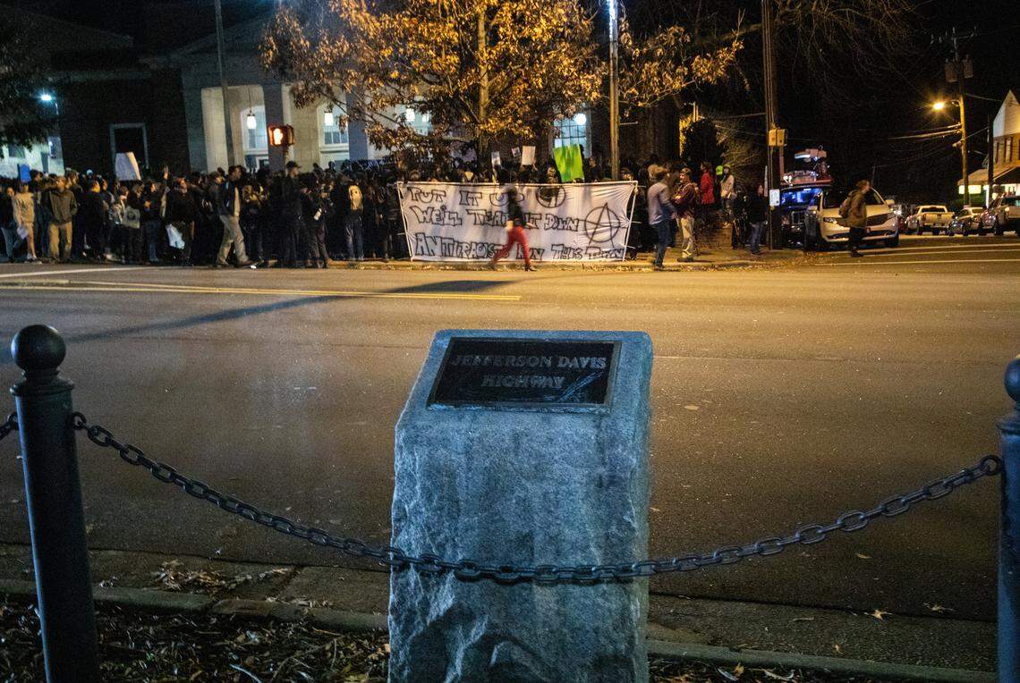Protesters rally across across the street from the Jefferson Davis marker on Franklin Street in Chapel Hill last December. The town of Chapel Hill removed the stone marker and plaque on Friday, Feb. 22, 2019.