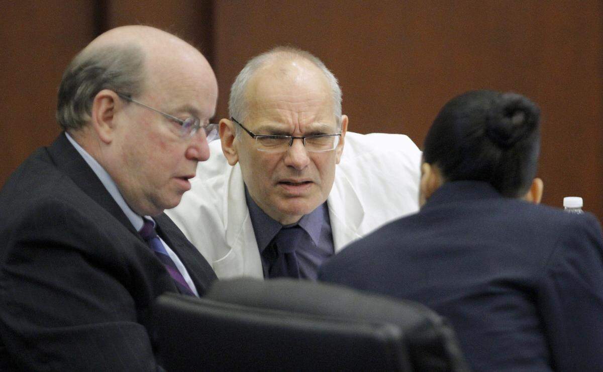 Moral Monday protest defendants Charles Van Der Horst, center, and Tye Hunter, left, confer with attorney Geeta Kapur, right, as they have their cases tried in Wake Co. District Court on Nov. 6, 2013.