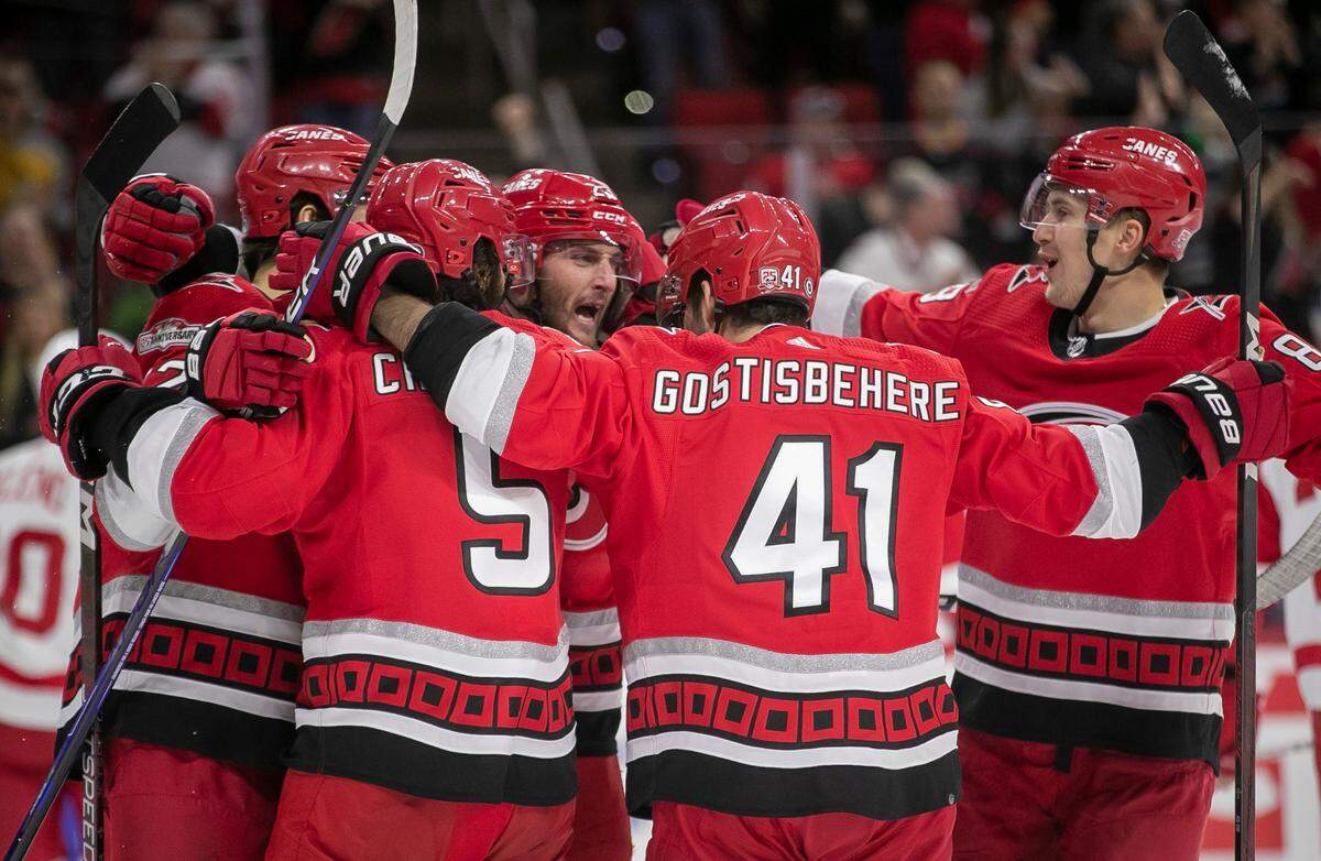 Carolina Hurricanes’ Stefan Noesen (23) is surrounded by teammates after scoring on Detroit goalie Alex Nedeljkovic (39) to give the Hurricanes a 1-0 lead in the first period on Tuesday, April 11, 2023 at PNC Arena in Raleigh, N.C.