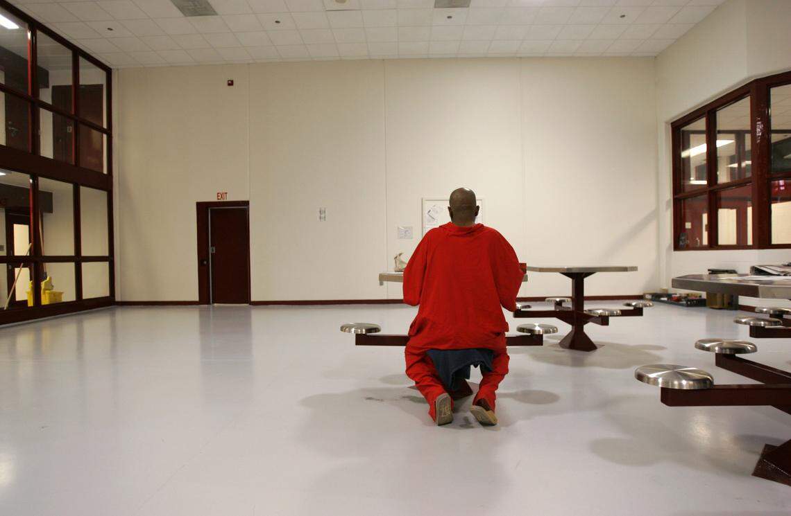 An inmate on death row at Central Prison in Raleigh works on a letter in a common area in one of the four pods on death row.