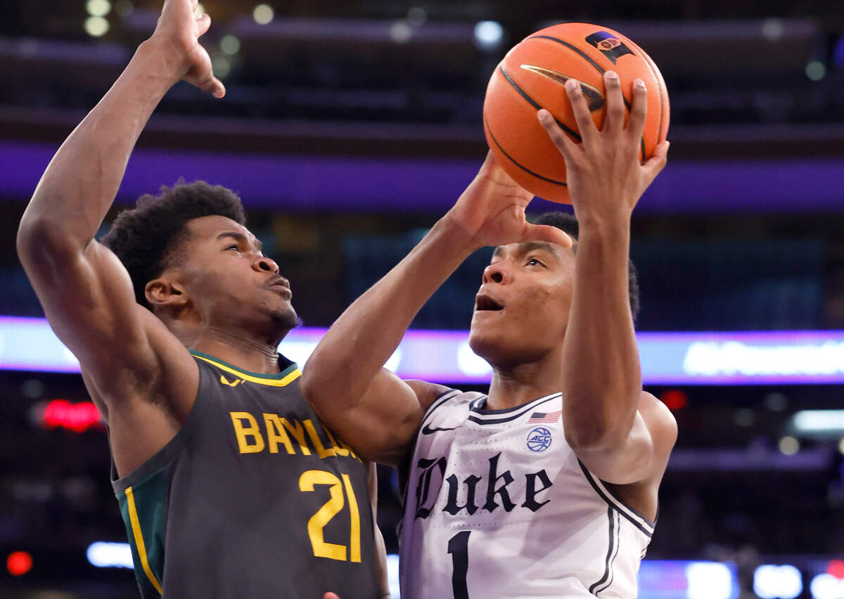 Duke’s Caleb Foster (1) heads to the basket as Baylor’s Yves Missi (21) defends during the second half of Duke’s 78-70 victory over Baylor at Madison Square Garden in New York City Wednesday, Dec. 20, 2023.