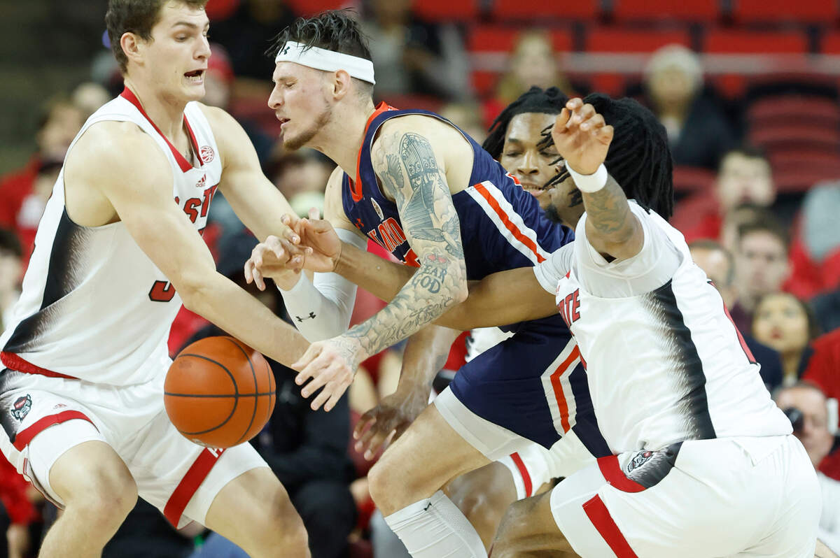N.C. State’s Ben Middlebrooks (34) and Jayden Taylor (1) knock the ball from UT Martin’s Jacob Crews (35) during the first half of N.C. State’s game against UT Martin at PNC Arena in Raleigh, N.C., Tuesday, Dec. 12, 2023.