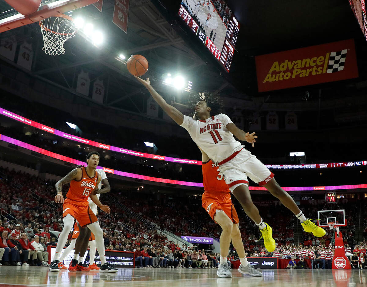 N.C. State’s Dennis Parker Jr. leans around Virginia Tech’s Robbie Beran to put up a shot during the second half of the Wolfpack’s 84-78 loss on Saturday, Jan. 20, 2024, at PNC Arena in Raleigh, N.C.
