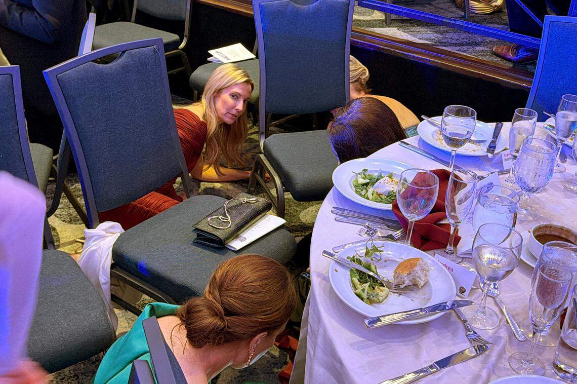 Guests take cover after U.S. President Donald Trump and first lady Melania Trump were rushed out of the White House Correspondents' Association dinner by Secret Service agents after a loud, unidentified noise, in Washington, D.C., U.S. April 25, 2026. Picture taken using a mobile phone. REUTERS/Evan Vucci     TPX IMAGES OF THE DAY     