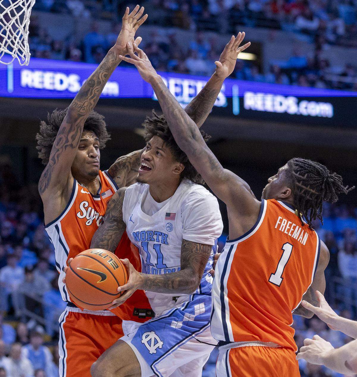 North Carolina guard Jonathan Powell (11) drives to the basket between Syracuse forwards Sadiq White Jr. (0) and Donnie Freeman (1) in the second half on Monday, February 2, 2026 at the Smith Center in Chapel Hill, N.C. 