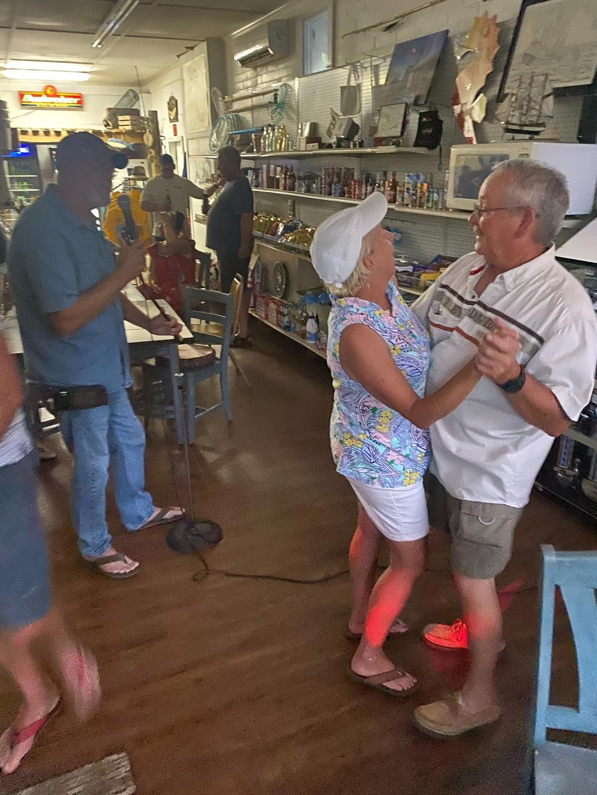 Debbie and Russ Hudson, married 44 years in their hometown of Vandemere, dance to James Eldridge’s rendition of “Wonderful Tonight,” a highlight of the karaoke night in their store, Squidders Bait & Tackle.