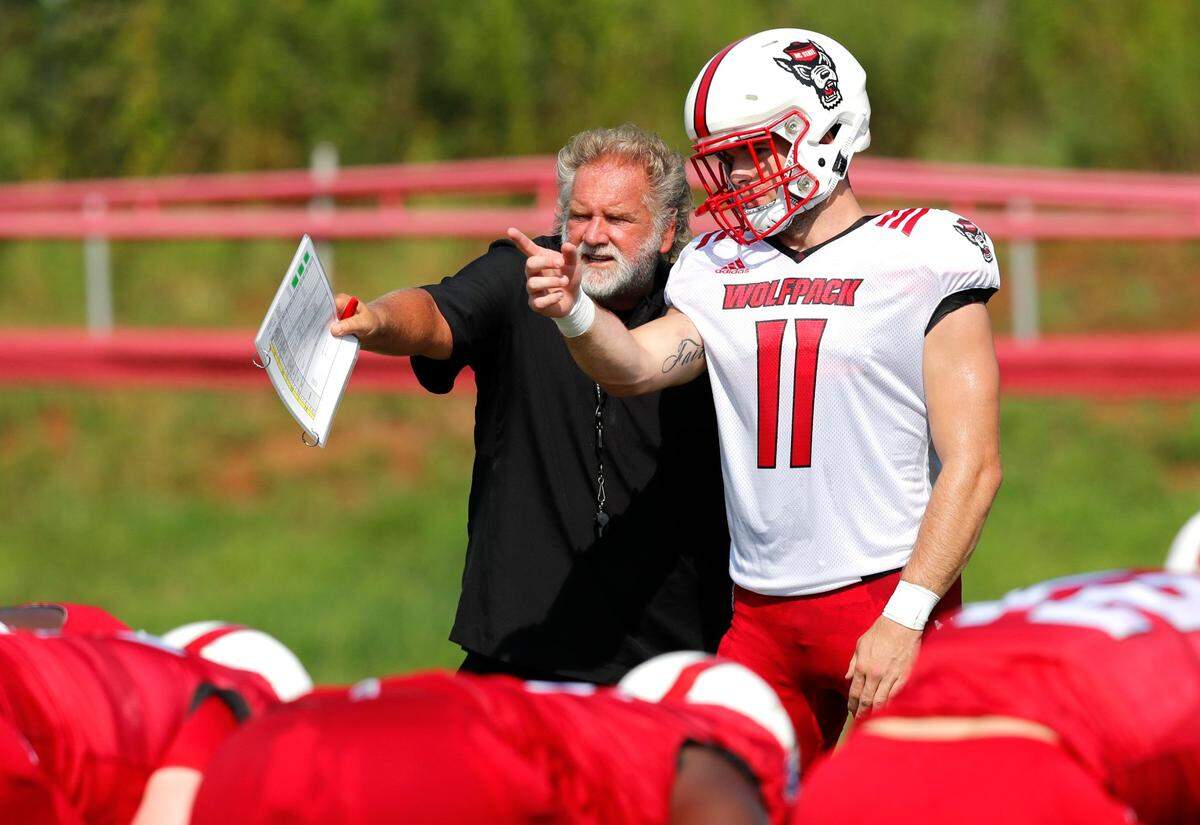 N.C. State defensive coordinator/linebackers coach Dave Huxtable talks with linebacker Payton Wilson (11) during the Wolfpack’s practice in Raleigh, N.C. Tuesday, August 6, 2019.