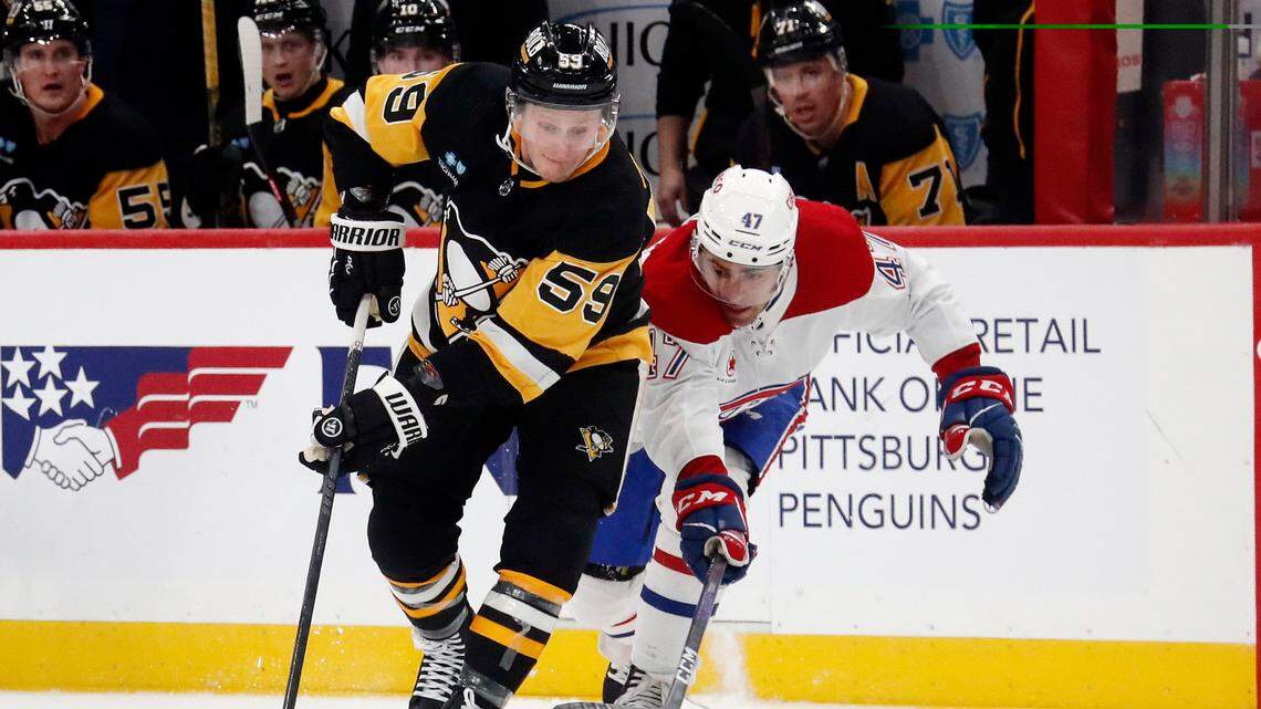 Jan 27, 2024; Pittsburgh, Pennsylvania, USA; Pittsburgh Penguins left wing Jake Guentzel (59) moves the puck against Montreal Canadiens defenseman Jayden Struble (47) during the third period at PPG Paints Arena. The Penguins won 3-2 in overtime.Mandatory Credit: Charles LeClaire-USA TODAY Sports