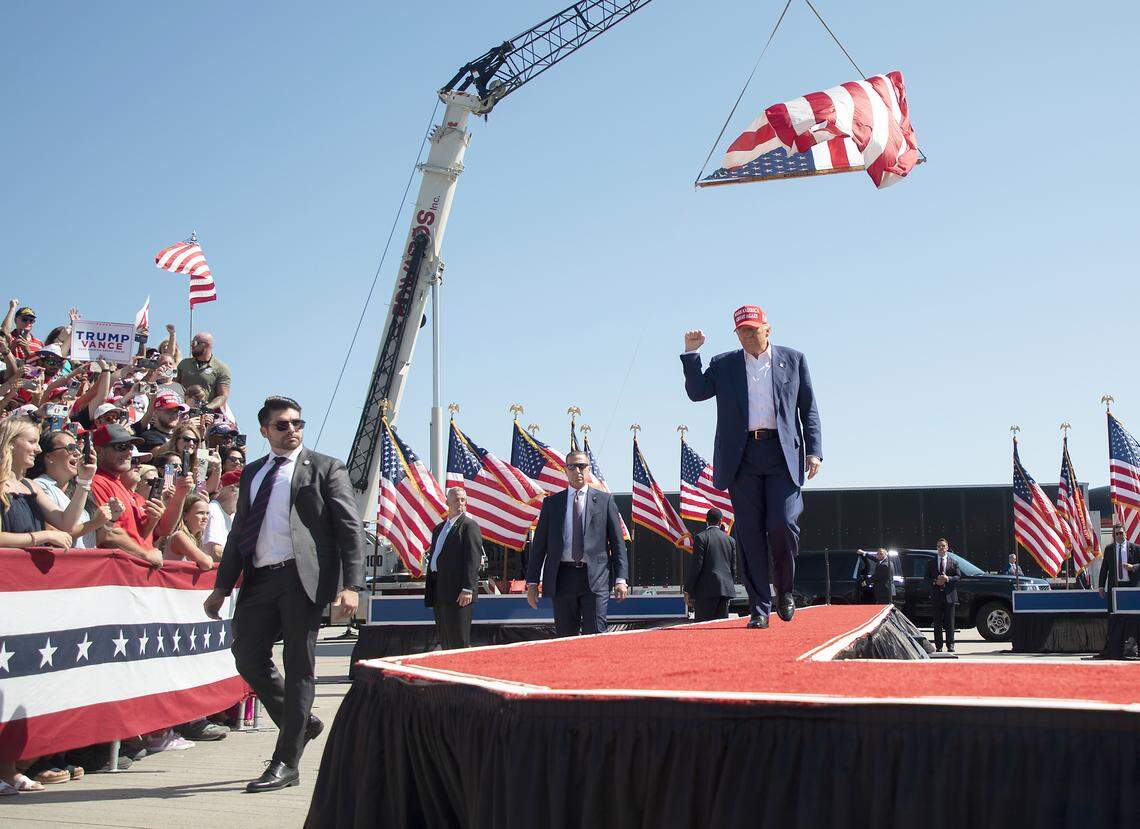 Former President Donald Trump walks the red carpet as he arrives for a campaign rally in Wilmington, NC, on Saturday, Sept, 21, 2024.