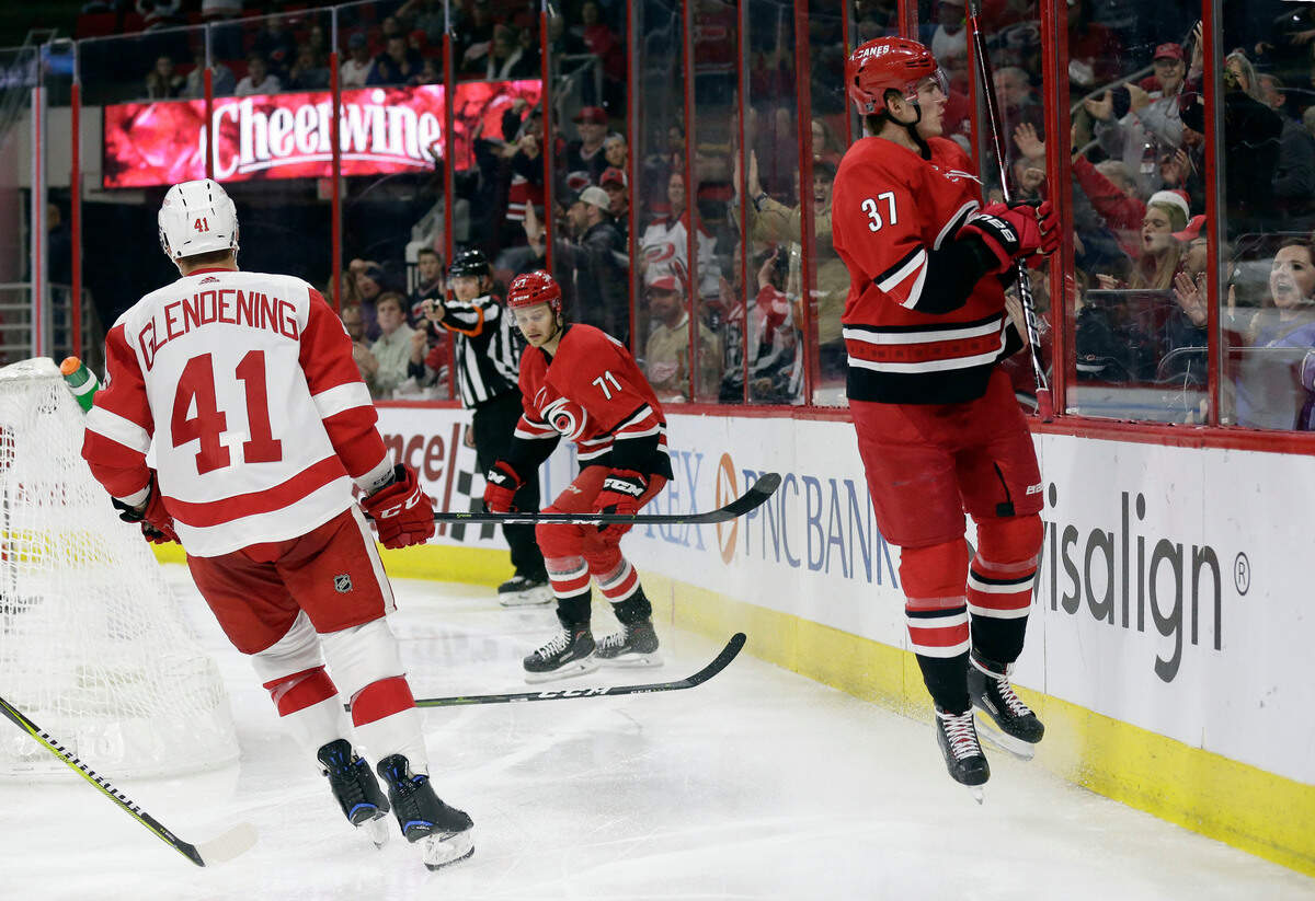 Carolina Hurricanes’ Andrei Svechnikov (37), of Russia, celebrates and jumps onto the glass following his goal against the Detroit Red Wings during the second period of an NHL hockey game in Raleigh, N.C., Thursday, Dec. 20, 2018. (AP Photo/Gerry Broome)