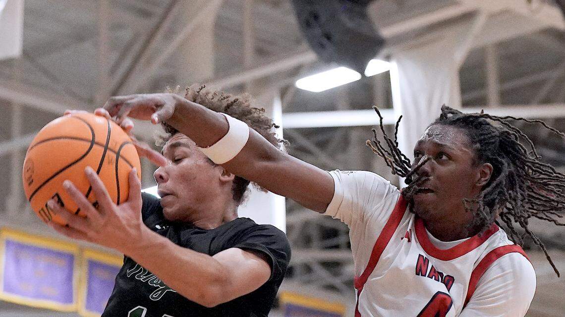 Greenfield's Cameron Moore (14) controls the rebound against Coronado's Amare Oba (4) during the first half. The Greenfield Knights and the Coronado Cougars (Nevada) met in the finals of the Day'Ron Sharpe bracket of the  John Wall Holiday Tournament in Raleigh, N.C. on December 30, 2025.