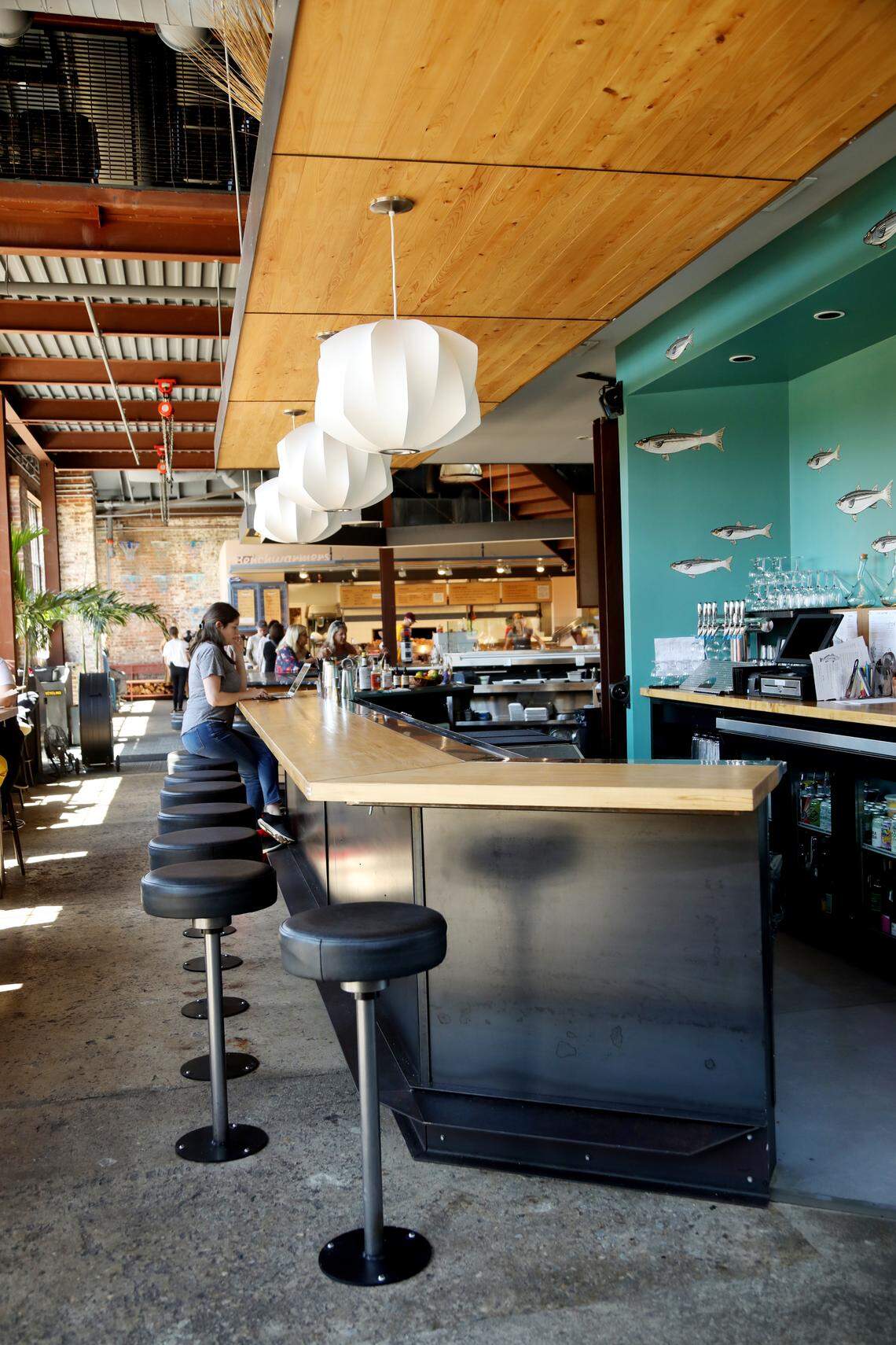 Locals Oyster Bar located in Transfer Food Hall Co. has an industrial modern feel.